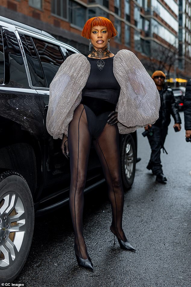 Laverne Cox arrived in an outfit that looked as if it was inspired by Grace Jones. She rocked a slim black bodysuit with puffy gray sequin-covered sleeves, and she showcased her fit legs in black stockings culminating in dangerously pointy black stilettos