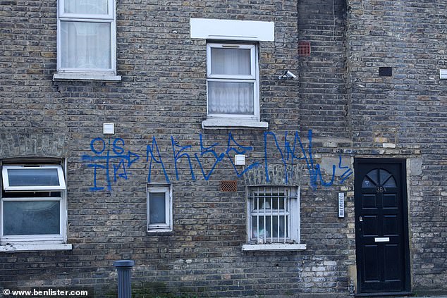 Blue graffiti on a brick building. Better value homes is among reasons cited by residents as to why they picked the area