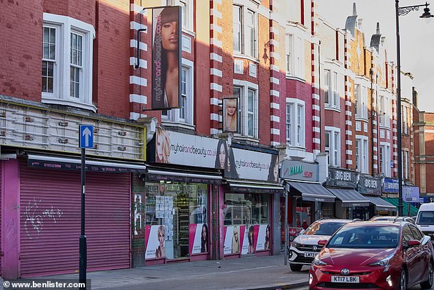 A row of shops in a red brick terrace building. The town is full of a vibrant mix of shops