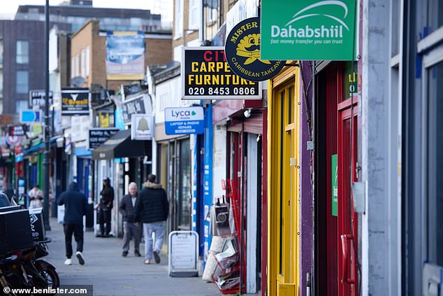 A variety of shops on Harlesden's high street, including furniture and phone stores