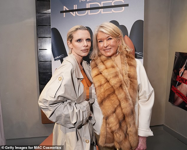 Martha Stewart didn't look fazed at all as she beamed while posing next to Julia, who made sure to pull her trench coat open to reveal her chest