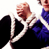 Alan Davies tied in white rope.