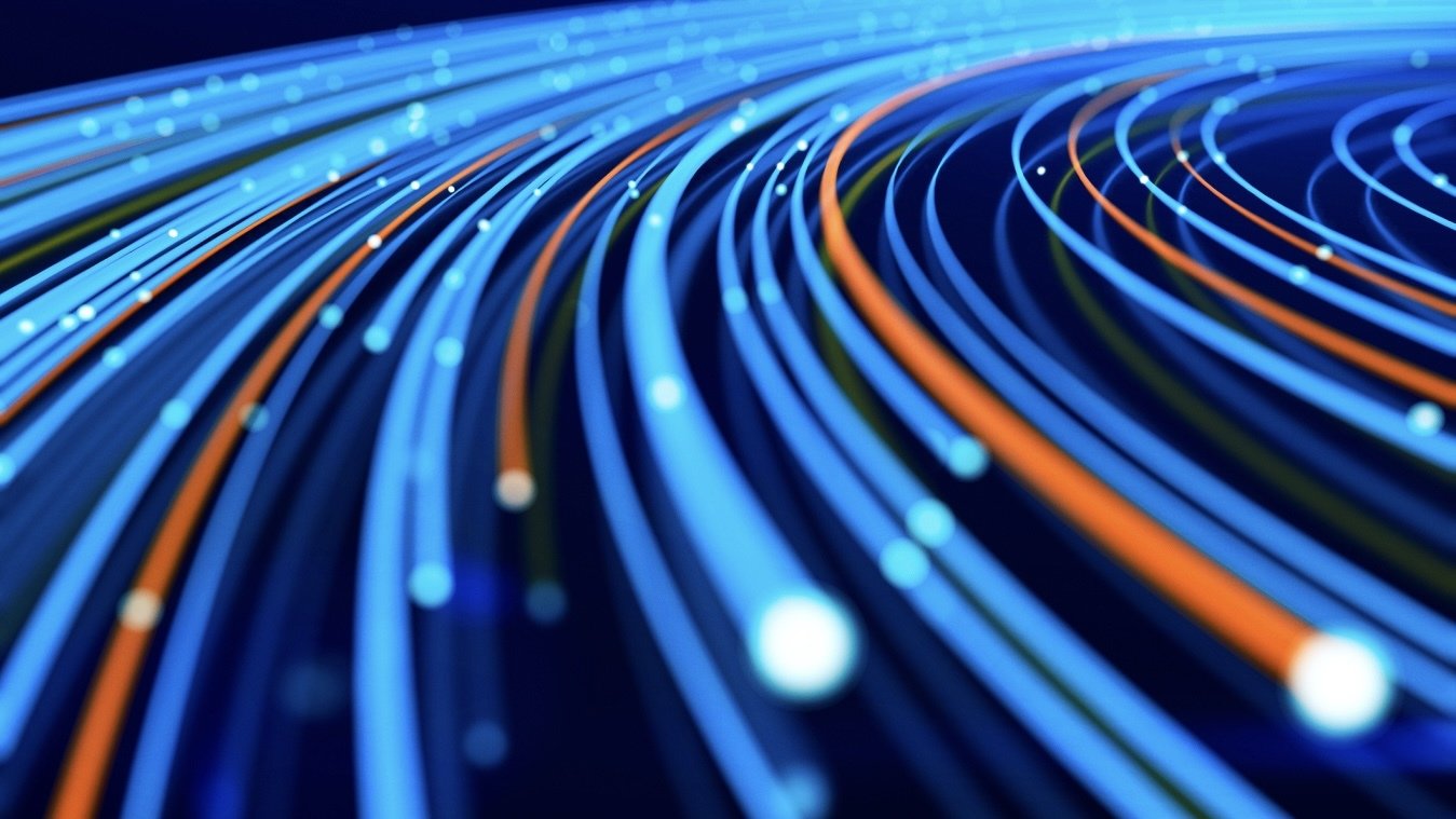 An illustration visualizes data zipping along fiber-optic cables in front of a dark blue background