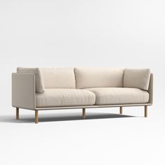 a white couch sitting on top of a wooden frame