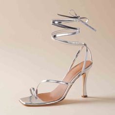 Elevate your wedding ensemble with these stunning silver square toe stiletto heel sandals. The strappy design adds an alluring touch, making them the perfect choice for any glamorous occasion. Handcrafted US sizing. Fits true to size. Heel Height: 3.15" / 80 mm approx Product measurements were taken using size 8. Please note that measurements may vary by size Sleek Silver Ankle Strap Heels, Silver Fitted Heels With Open Heel, Silver Open Heel Heels, Silver Strappy Sandals For Party, Sleek Silver Heels With Wrapped Heel, Chic Silver Square Toe Heels, Sleek Silver Evening Sandals, Silver Strappy Heels With Wrapped Heel, Silver Sandals With Ankle Strap