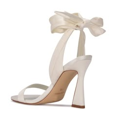 Step up your shoe game with the Nine West Kelsie dress sandal. This eye-catching style features a trendy sculpted high heel and soft textured fabric that wraps around the ankle. Trendy yet chic the Kelsie sandal will elevate any outfit. The perfect wardrobe essential! Cute White Heels Lulus, Shoes To Wear With Dresses Chart, Dream Prom Shoes, Ankle Wrap Heels, Dr Shoes, Gossip Girls, Pastel Outfit, Wrap Heels, Aesthetic Shoes