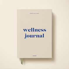 a white book with blue writing on it that says,'wellness journal '