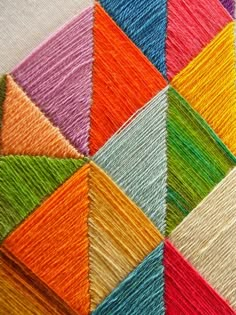 an image of some colorful yarns that are on a tablecloth or wall hanging