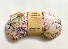 a pink flowered eye pillow with a cat on it's front and back