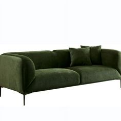 a green couch with two pillows on it