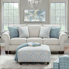 a living room scene with focus on the couch and ottoman