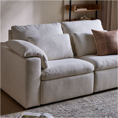 a white couch with two pillows on top of it