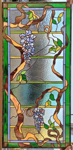 a stained glass window with vines on it