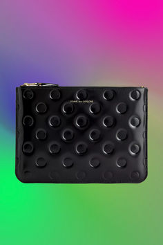 a black purse with lots of circles on it