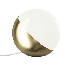 a white and gold lamp with a cord attached to the light bulb, on a white background