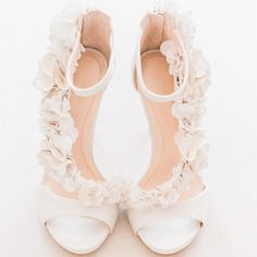 The Ivory Satin Wedding Shoes Floral Embellished Strappy Heeled Sandals exude grace and elegance, crafted from luxurious satin material and embellished with delicate satin flowers. These sandals boast a peep toe design, a back zipper, and a comfortable heel, making them perfect for bridal wear, ensuring both style and comfort on your special day. Handcrafted US sizing. Fits true to size. Heel Height: 4.72" / 120 mm approx Product measurements were taken using size 8. Please note that measurements may vary by size. Material: Crafted from elegant satin material for a luxurious look and feel. Peep Toe Design: Features a stylish peep toe front for added sophistication. Back Zipper: The back zipper design makes it easier to wear. Kasut Pengantin, Sepatu Pump, Bohemian Style Gown, Satin Wedding Shoes, Types Of Gowns, Ivory Wedding Shoes, Bridal Skirts, Ankle Strap Sandals Heels, Aisle Runner