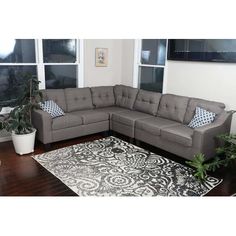 a living room with a sectional couch and rug