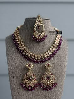 This exquisite Purple Golden antique Finish Beads necklace set with maangtikka is a must-have for any jewelry collection. The elegant purple and gold color combination exudes sophistication, while the antique finish adds a touch of vintage charm. Perfect for any special occasion, this set will surely make you stand out in a crowd. Add this stunning set to your wardrobe for a timeless and classy look. Indian Jewelry Purple, Jewellery For Purple Saree, Purple Jhumka Earrings, Jewellery For Purple Lehenga, Purple Jewelry Set Indian, Traditional Dangle Jewelry Set For Party, Wedding Jewelry Set With Matching Earrings, Festive Wedding Jewelry Sets With Matching Earrings, Formal Kundan Dangle Jewelry