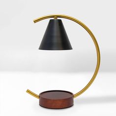 a table lamp with a wooden base and black shade on the top, against a white background