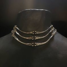 "Lead-free pewter cast chicken bone chokers. Each bone bar is 4\" x ¼\" Adjustable 14\" - 16\" See this listing for interchangeable pendant versions. https://www.etsy.com/listing/1204160736/bone-chokers-with-interchangeable?click_key=cc61314a71a59c20aee60a000413187b23f41fbe%3A1204160736&click_sum=a9392cb3&ref=shop_home_active_1&frs=1 Always ethically sourced bones. Nothing has ever been harmed for the purpose of our jewelry. All pieces are made-to-order despite the \"in stock\" number in the lis Animal Bone Jewelry Wire, Pewter Casting Jewellery, Bone Jewelry Aesthetic, Unique Metal Clavicle Chain Choker, Unique Adjustable Metal Choker, Hand Forged Metal Choker Necklace, Handmade Silver Punk Choker, Unique Metal Choker With Adjustable Chain, Nickel-free Metal Choker Jewelry