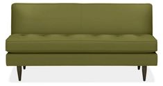 a green couch sitting on top of a white floor