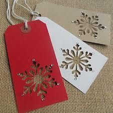 handmade christmas tags. Just a snowflake punch and some paper tags. lovely! The little drops of glitter add the perfect touch.