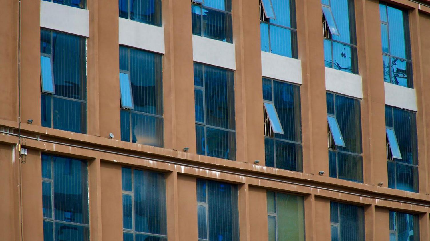 A row of windows with bars on the inside  