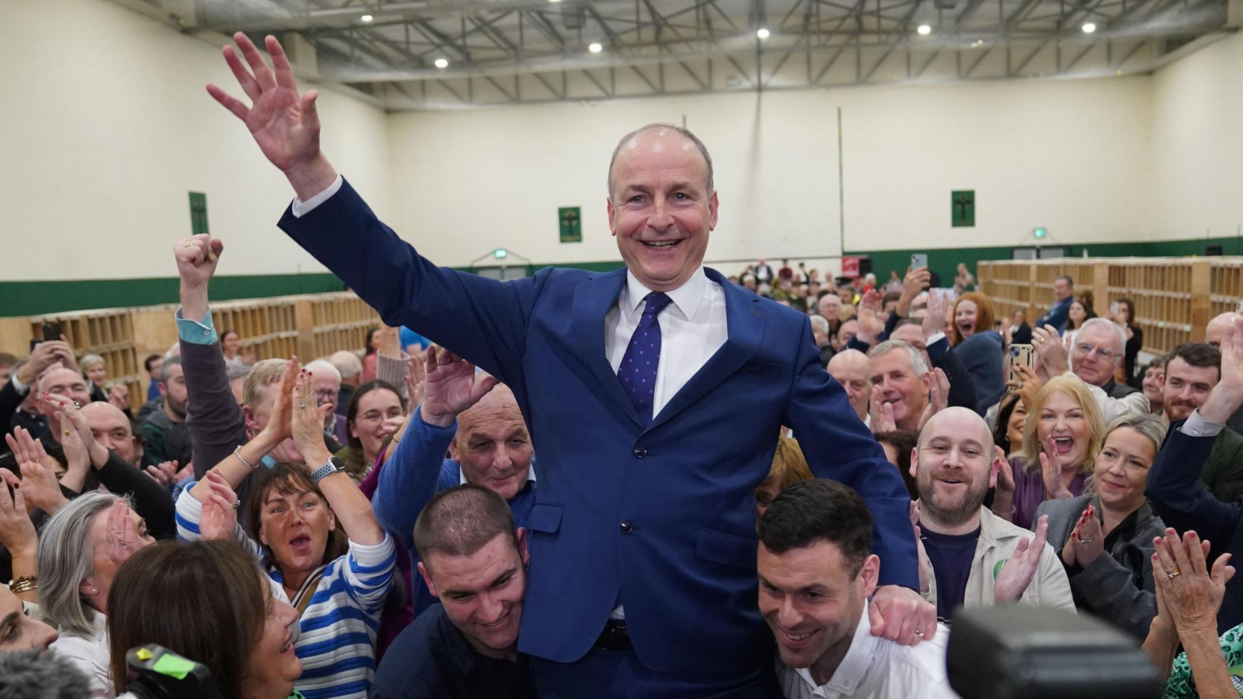 Fianna Fáil leader Micheál Martin is hoisted up by his sons Cillian and Micheal Aodh, after he was deemed elected in the Cork South Central