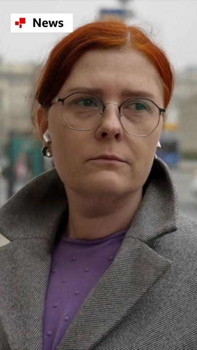 Lady with red hair standing in Moscow during an interview 