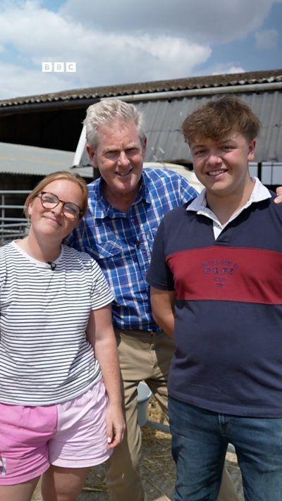 Three people in summer clothing smiling at the camera.