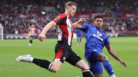 Nathan Collins and James Justin battle for the ball