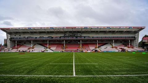 A general view across the pitch of a stand at Kingsholm stadium