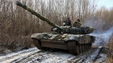 Servicemen of the 3rd Separate Tank Brigade of the Ground Forces of Ukraine operate a tank near the frontline at an undisclosed location in the Kharkiv region,