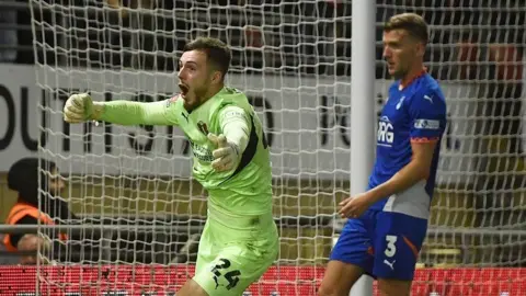 Leyton Orient goalkeeper Josh Keeley celebrates scoring against Oldham