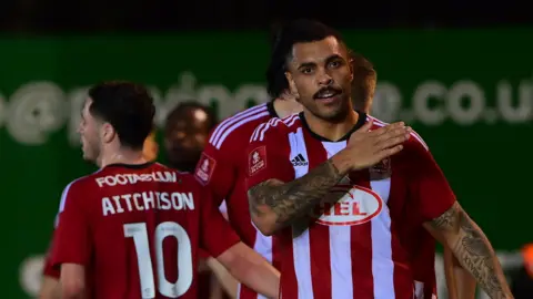 Exeter players celebrate a goal against Chesterfield