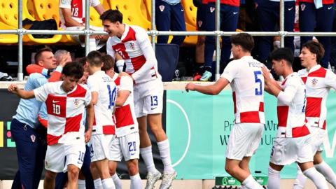 Croatia players celebrate a goal against Serbia