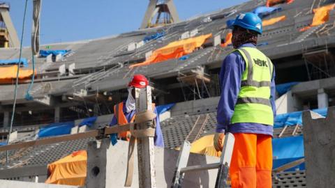 Construction workers at the Lusail Stadium in Doha in 2019 ahead of the 2022 World Cup