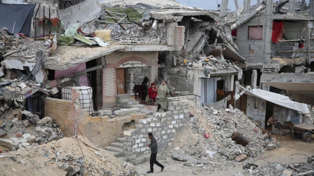 Palestinians gathered at a ruined building in Gaza