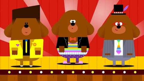 Hey Duggee on stage with various fancy outfits!