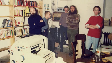 Five environmental activists in a basement in East Berlin stand by a printer (Credit: The Stasi Records Archive)