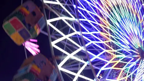 Brightly lit ferris wheel at India's Kumbh Mela