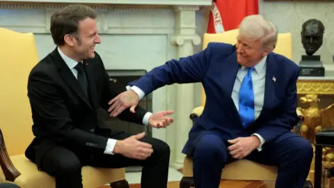 Macron and Trump laughing together in Oval Office