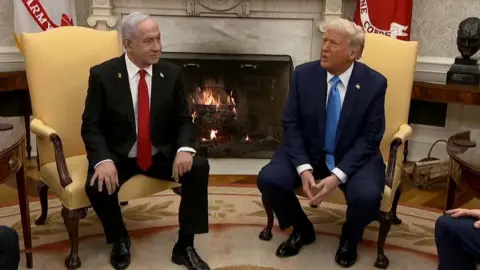 Israeli Prime Minister Benjamin Netanyahu sits next to US President Donald Trump during a press conference