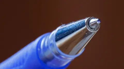 Close-up image of a blue and silver rollerball pen