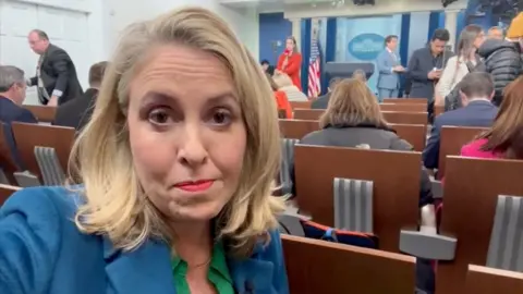 Sarah Smith sits in the White House press briefing room.