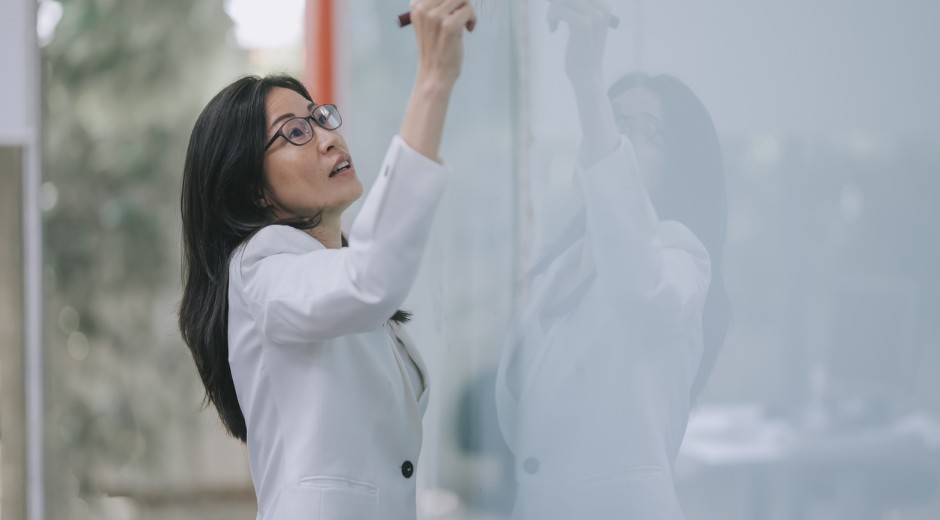 Education professional writing on a whiteboard