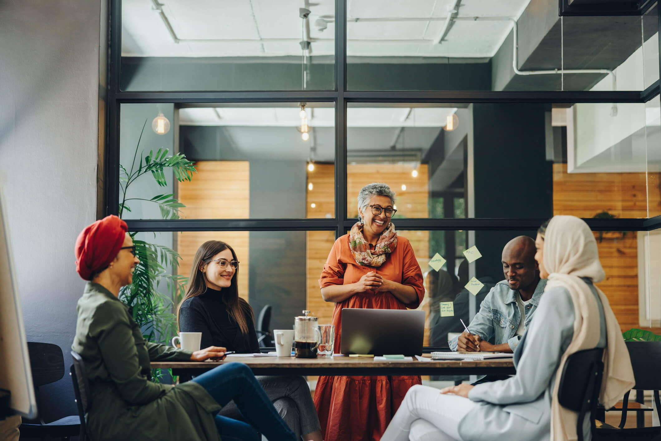 A group of people sitting around a table in an office.