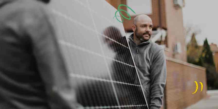 Hero of two people lifting a solar panel to install. 