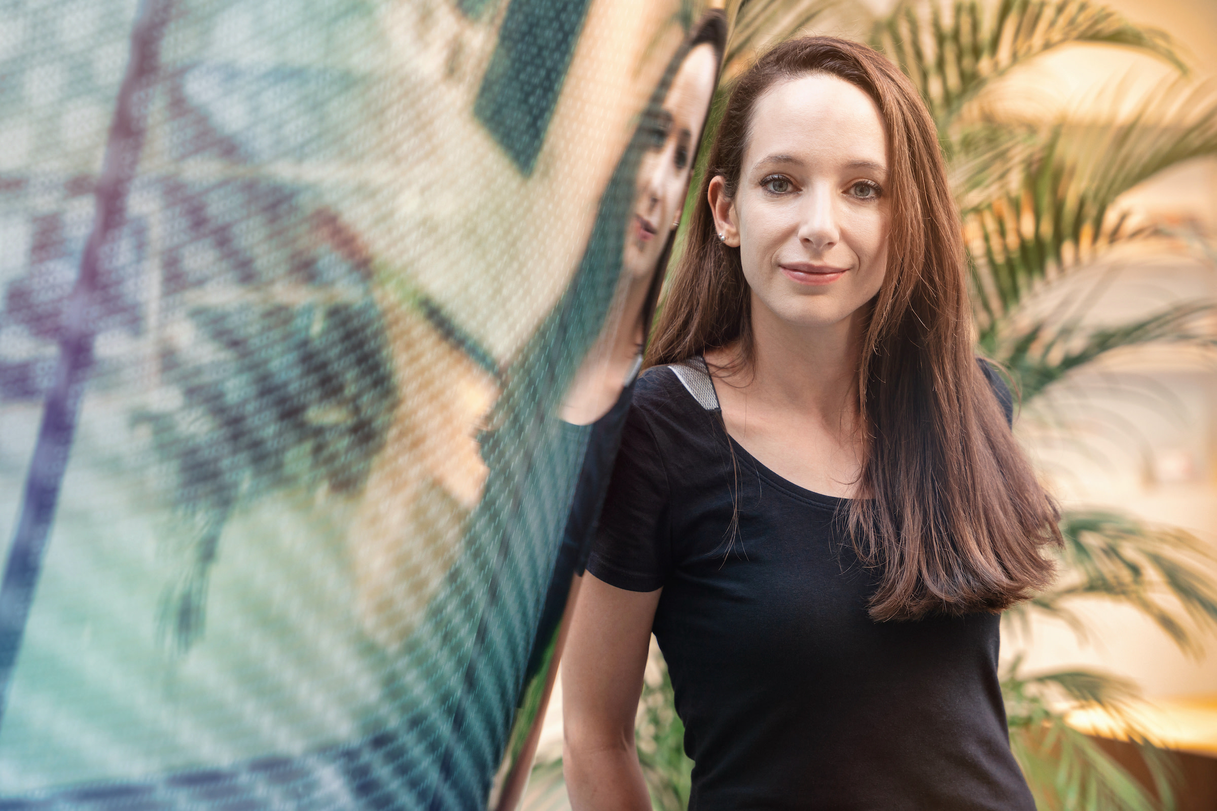 Author Johanna smiling at the camera in an urban space