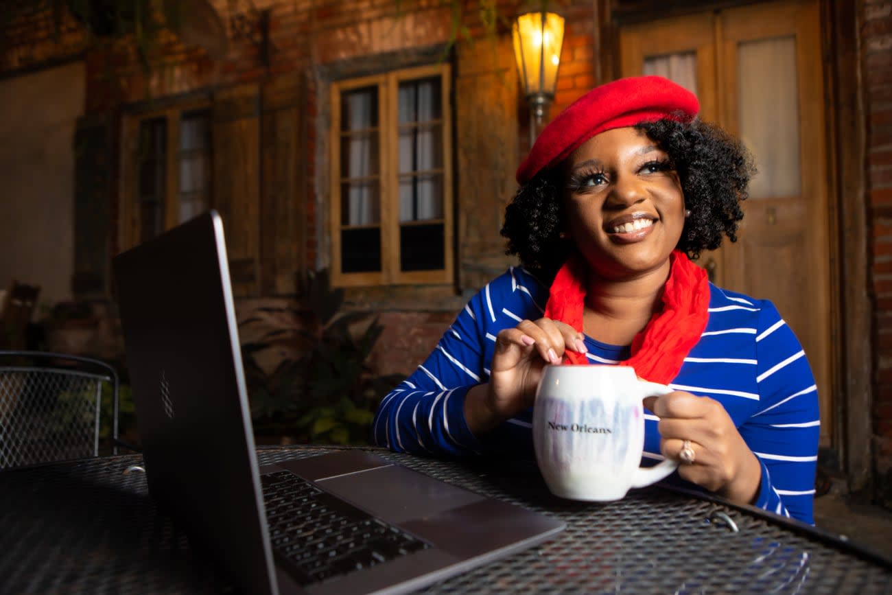 Photo of Angie Jones at a cafe with a laptop.